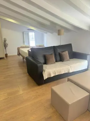 a living room with a couch and a bed at Valencia Bella Flats in Valencia