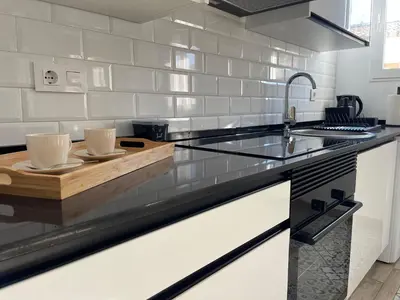 a kitchen with a counter with two cups on it at Apartamento El Castell in Alaquas