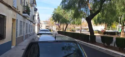 a row of parked cars parked on a street at Apartamento El Castell in Alaquas