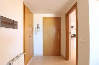 a hallway with a wooden door in a house at Enorme terraza con vistas al mar by Hometels in Puerto de Sagunto