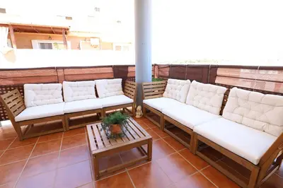 a row of white couches on a balcony at Enorme terraza con vistas al mar by Hometels in Puerto de Sagunto