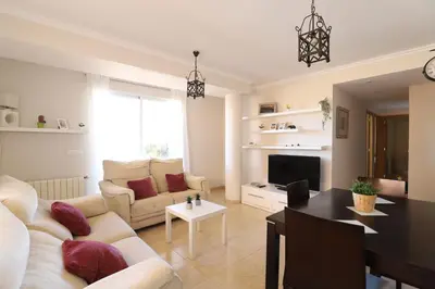 a living room with a couch and a table at Enorme terraza con vistas al mar by Hometels in Puerto de Sagunto
