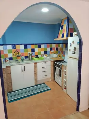 a kitchen with an archway in the middle of it at Casa Rural Judith in Segorbe