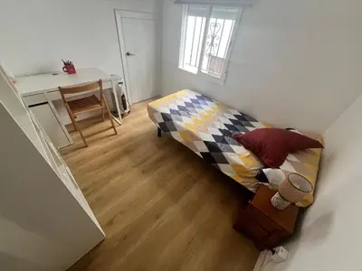 a small room with a bed and a desk at Casa Rural Judith in Segorbe