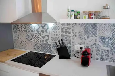 a kitchen with a counter top with a stove top at Studio chic avec terrasse, lumineux et calme 1 in Valencia