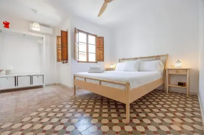 a bedroom with a large bed and a window at Artisan Haven: El Cabanyal Oasis in Valencia