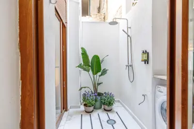 a bathroom with potted plants on a tiled floor at Artisan Haven: El Cabanyal Oasis in Valencia