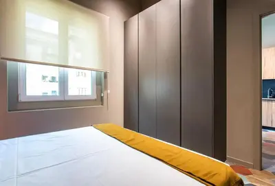 a bedroom with a bed with a yellow blanket on it at REINA FLATS VALENCIA Playa in Valencia
