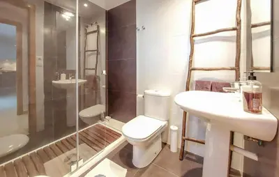 a bathroom with a toilet and a sink and a shower at Awesome Apartment In Moncofa in Moncófar