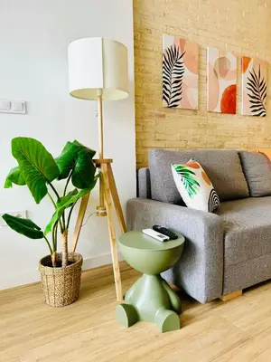 a living room with a couch and a lamp at Beautiful Flat NEXT the BEACH in Valencia