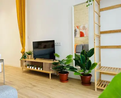 a living room with a tv and some plants at Beautiful Flat NEXT the BEACH in Valencia
