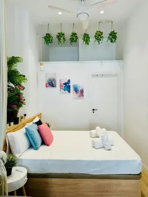 a room with a bed with colorful pillows on it at Nice & Cozy Flat Close The Beach in Valencia