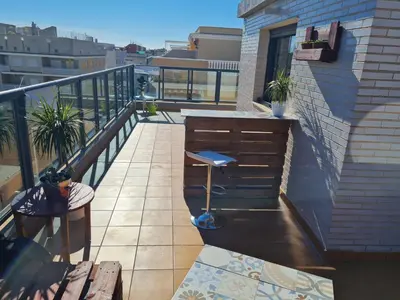 a balcony with a table and bench on a building at Attic terrace 360 Moncofa in Moncófar
