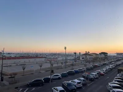 a parking lot filled with lots of parked cars at Frente al puerto y junto a la playa del Arenal in Burriana