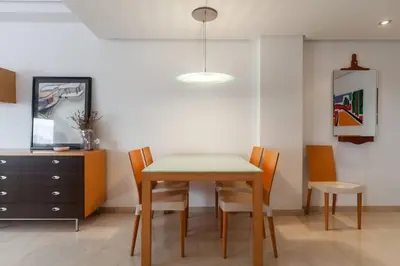 a dining room with a table and chairs and a dresser at Valencia las Artes y Ciencias + Garaje + Netflix in Valencia