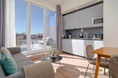 a living room with a couch and a table at Limehome Valencia Carrer de Sant Jacint in Valencia