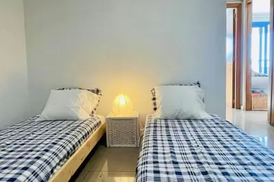 two beds sitting next to each other in a room at Apto. luminoso con vistas en playa de La Patacona in Valencia