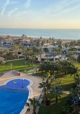 an aerial view of a resort with a swimming pool and the ocean at Apto. luminoso con vistas en playa de La Patacona in Valencia