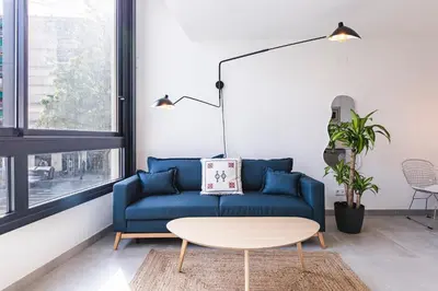 a living room with a blue couch and a table at Valencia Apartments by Olala Homes in Valencia
