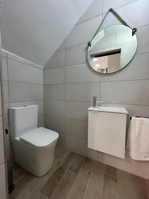 a bathroom with a toilet and a mirror at CAN´SELMA 1 in Chella