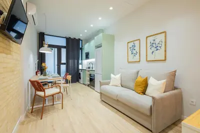 a living room with a couch and a table at FLORIT FLATS - The Joaquin Sorolla Station Apartments in Valencia