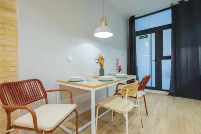 a dining room with a white table and chairs at FLORIT FLATS - The Joaquin Sorolla Station Apartments in Valencia