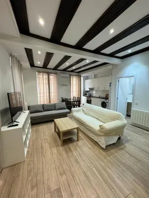 a bedroom with a bed and a couch and a table at Mercado CENTRAL on 1th FLOOR in Valencia