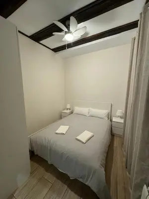 a bedroom with a bed with two towels on it at Mercado CENTRAL on 1th FLOOR in Valencia