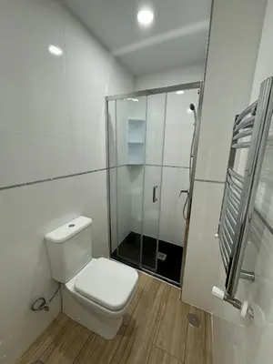 a white bathroom with a toilet and a shower at Mercado CENTRAL on 1th FLOOR in Valencia