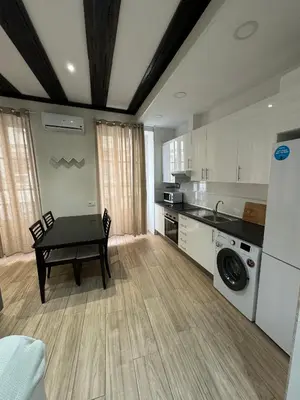 a kitchen with a table and a washing machine at Mercado CENTRAL on 1th FLOOR in Valencia