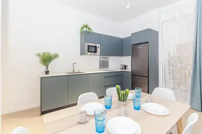 a kitchen and dining room with a table and chairs at GuestReady - Valencia's Vibrant Malvarrosa in Valencia