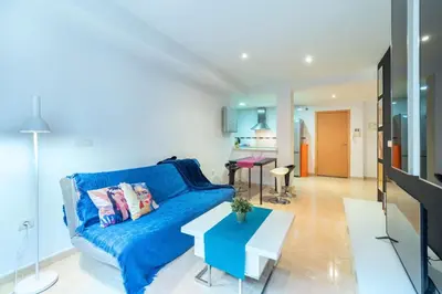 a living room with a blue couch and a table at El estudio de Inma in Burriana