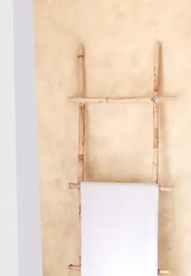 a white refrigerator against a wall with two sticks at Casa Lola - Con 2 terrazas, ideal para desconectar in Requena