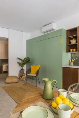 a table with plates and fruit on it in a room at Green suite by Concept Flats in Valencia