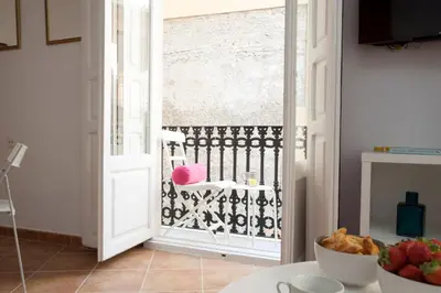 a kitchen with a door open to a balcony at SingularStays Roteros in Valencia