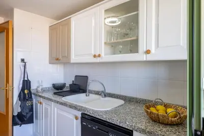 a kitchen with a sink and a basket of fruit at SAPORE DI MARE in Valencia