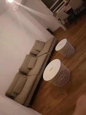 a living room with a couch and two tables at habitaciones patraix in Valencia