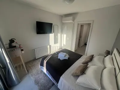 a bedroom with a bed and a tv on the wall at Valencia Old Town Suite in Valencia