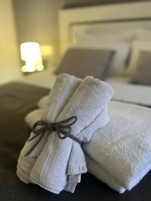 a pile of towels sitting on top of a bed at Valencia Old Town Suite in Valencia