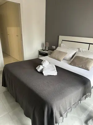 a bedroom with a large bed with two towels on it at Valencia Old Town Suite in Valencia