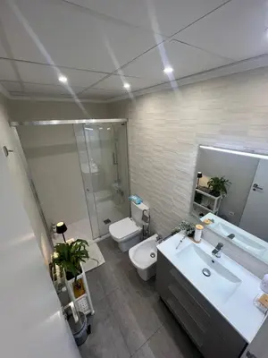 a bathroom with a sink and a toilet and a mirror at Valencia Old Town Suite in Valencia