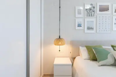 a bedroom with a white bed and a lamp at DormForYou Jose Maria Haro in Valencia