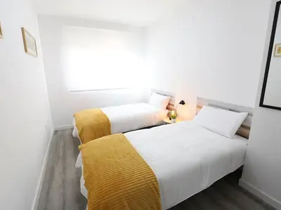 two beds sitting next to each other in a room at Esplendido apartamento para 6 personas by Hometels in Puerto de Sagunto