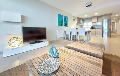 a living room with a flat screen tv and a table at 2 Bedroom Awesome Apartment In Moncofa in Moncófar