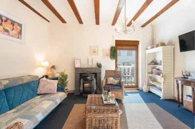 a living room with a blue couch and a fireplace at Ensueño Alojamiento Turístico in Alcublas