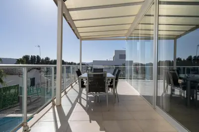 a balcony with a table and chairs on it at Descubre Villa Oasis - Confort, diseño y naturaleza a un paso de Valencia in Chiva