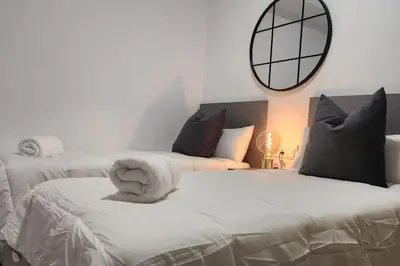 two beds in a bedroom with a mirror on the wall at Casa Valencia al mar in Valencia
