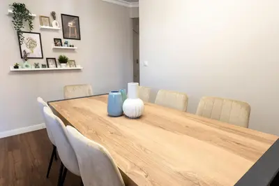 a dining room table with chairs and vases on it at Nice lodging near the Plaza de Toros in Valencia