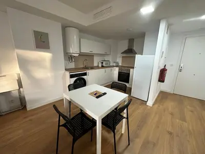a kitchen with a table and chairs in a room at Apartamentos Canet al Mar. in Canet de Berenguer