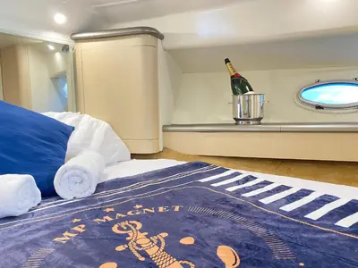 a small bedroom with a bed and a shelf at The Valencia Yacht Experience in Valencia
